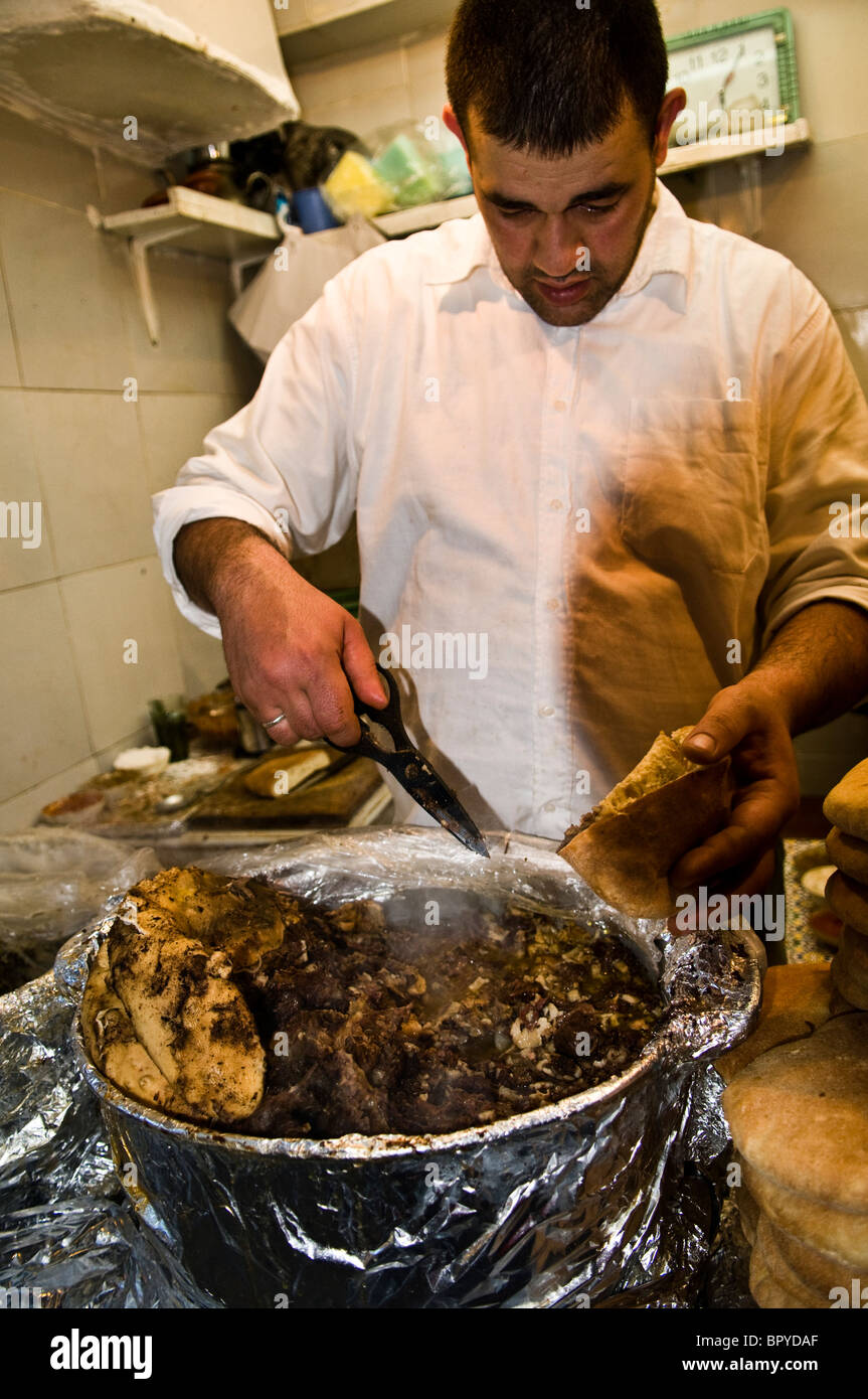 Sheep head and other traditional dishes cooked in a hole in the wall restaurant in Fes, Morocco. Stock Photo