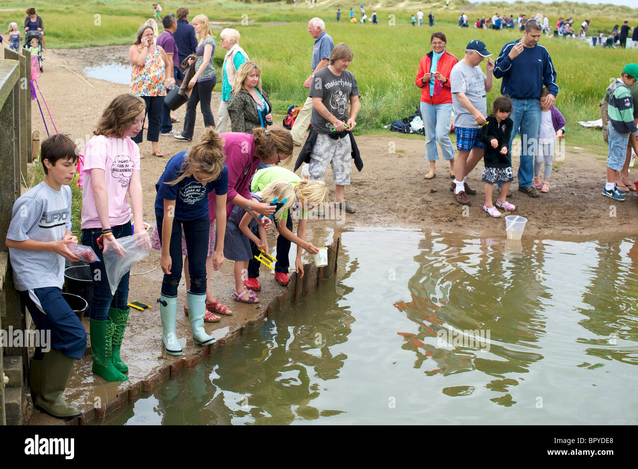 Rods hooks & fishing nets in use children playing catching crab at