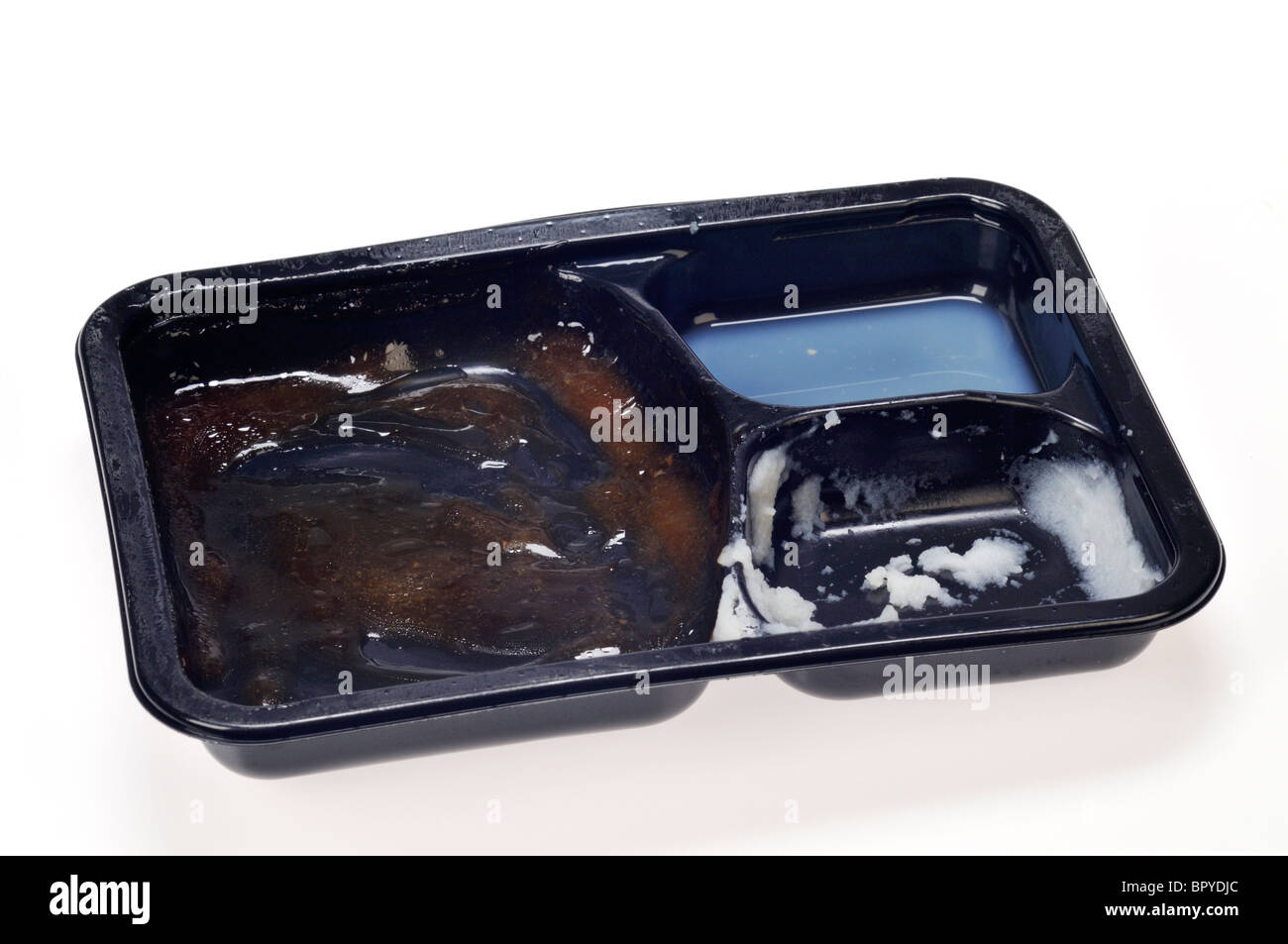 A ready meal tv dinner tray empty, that has been eaten on white background cut out. Stock Photo