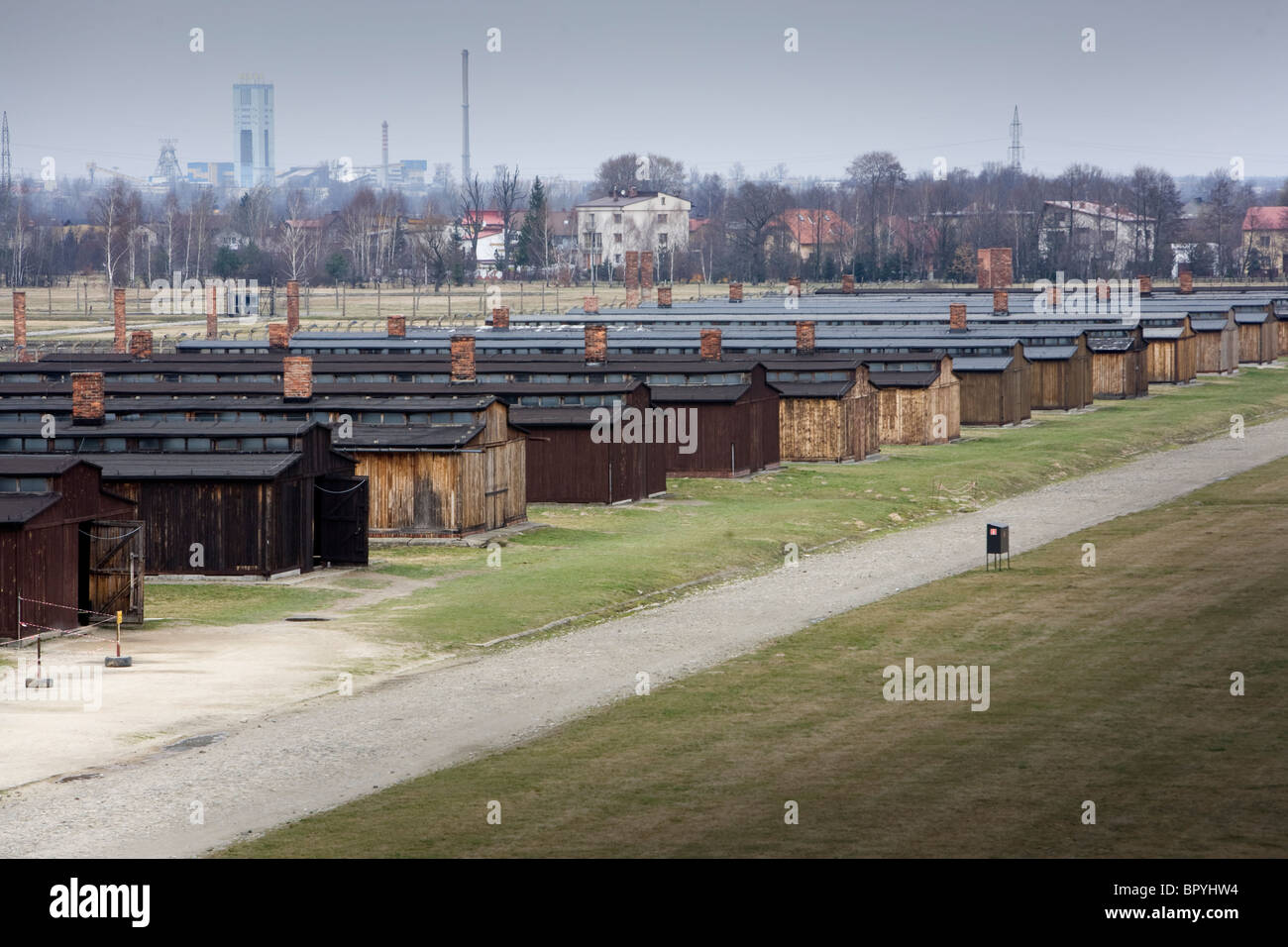 Accommodation huts still standing with demolished ones in background at Auschwitz Birkenau Concentration camp, Poland. Stock Photo