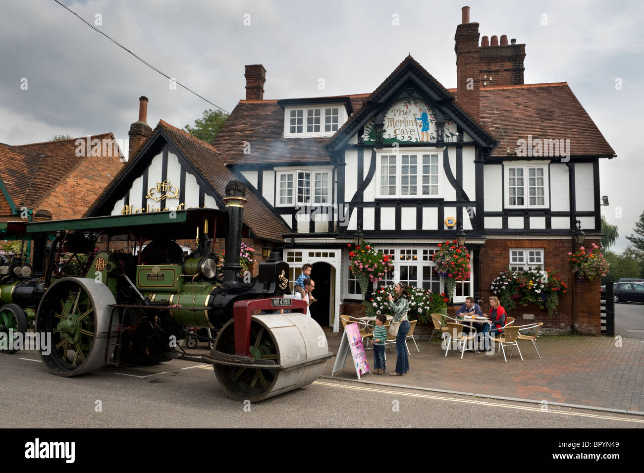 Steam traction engine and road roller parked outside the Merlins Cave a local pub in Chalfont St Giles Buckinghamshire UK Stock Photo