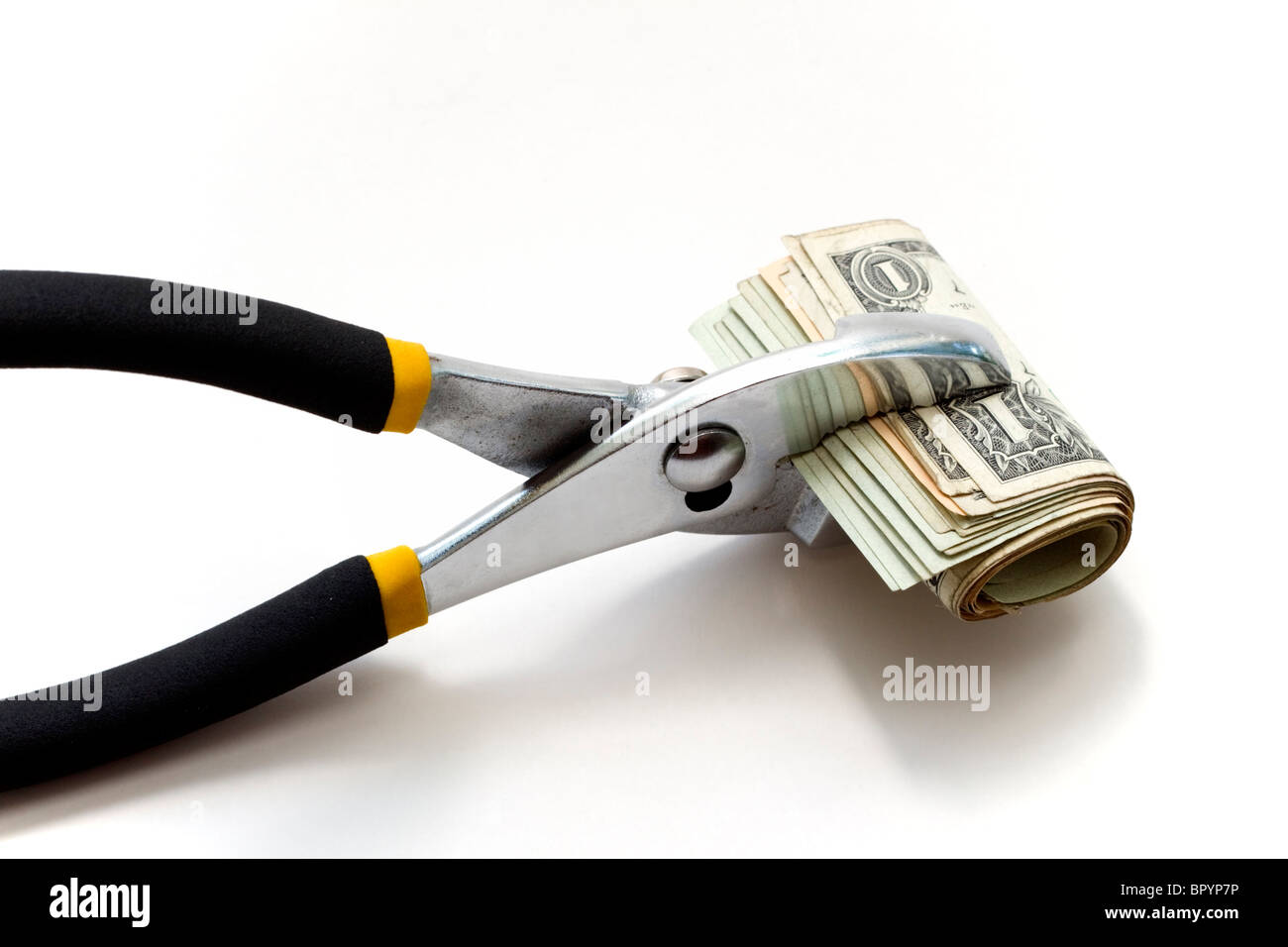 A roll of money being squeezed, conceptual image illustrating trouble in financial markets Stock Photo