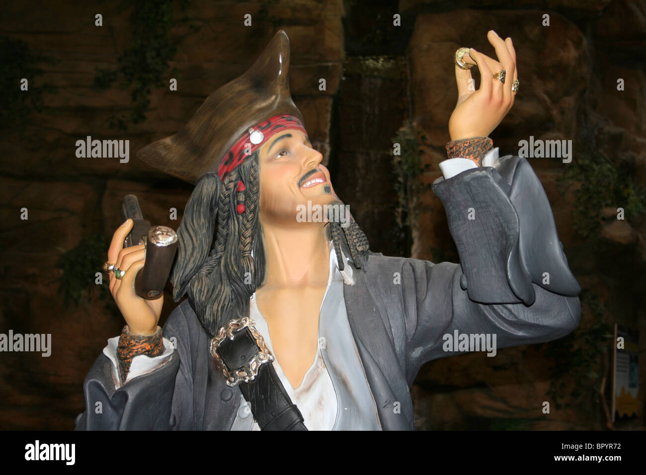 Model Of A Pirate Holding Gold Treasure Coin Stock Photo