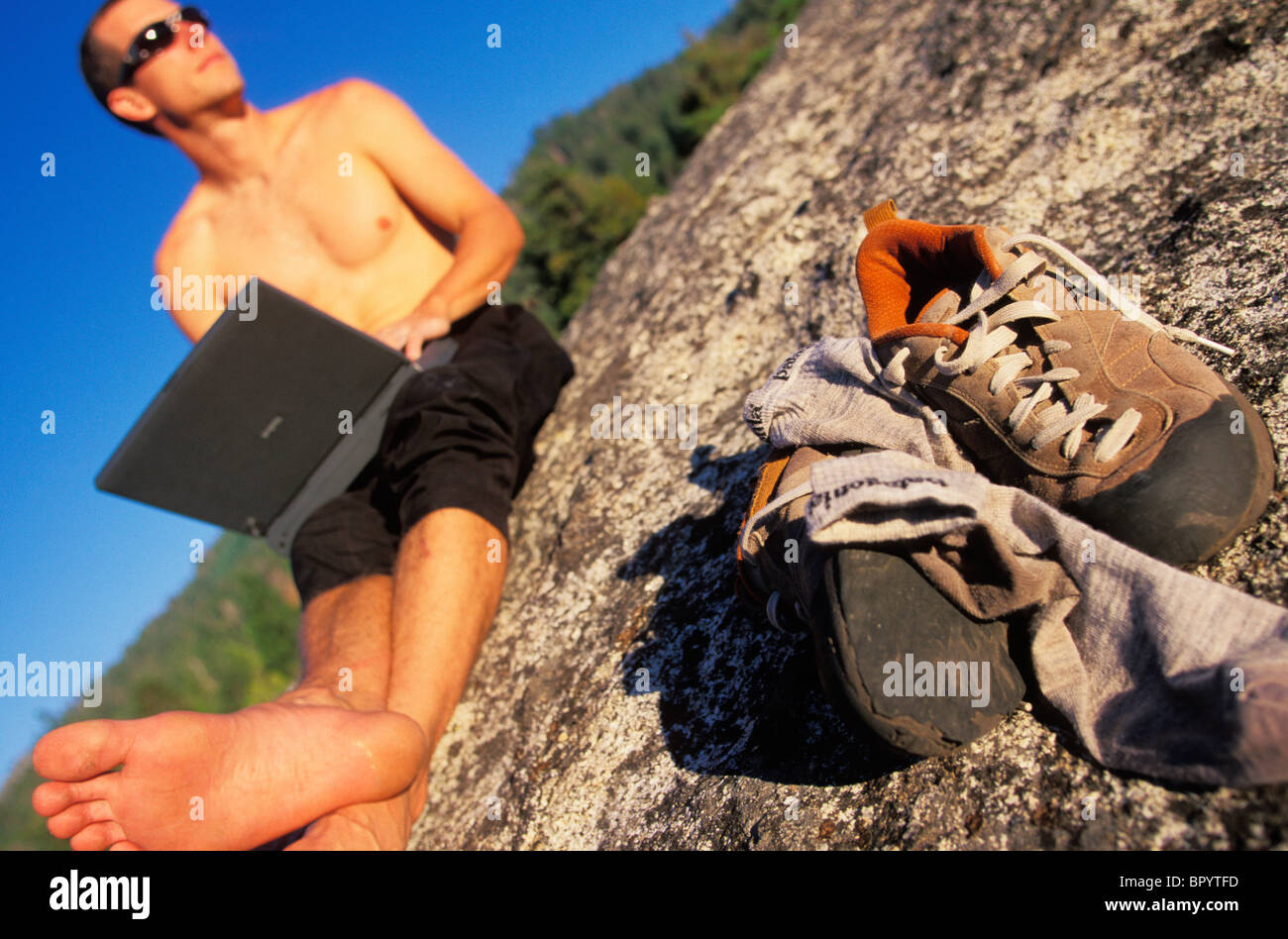 A man uses technology in backcountry Stock Photo Alamy