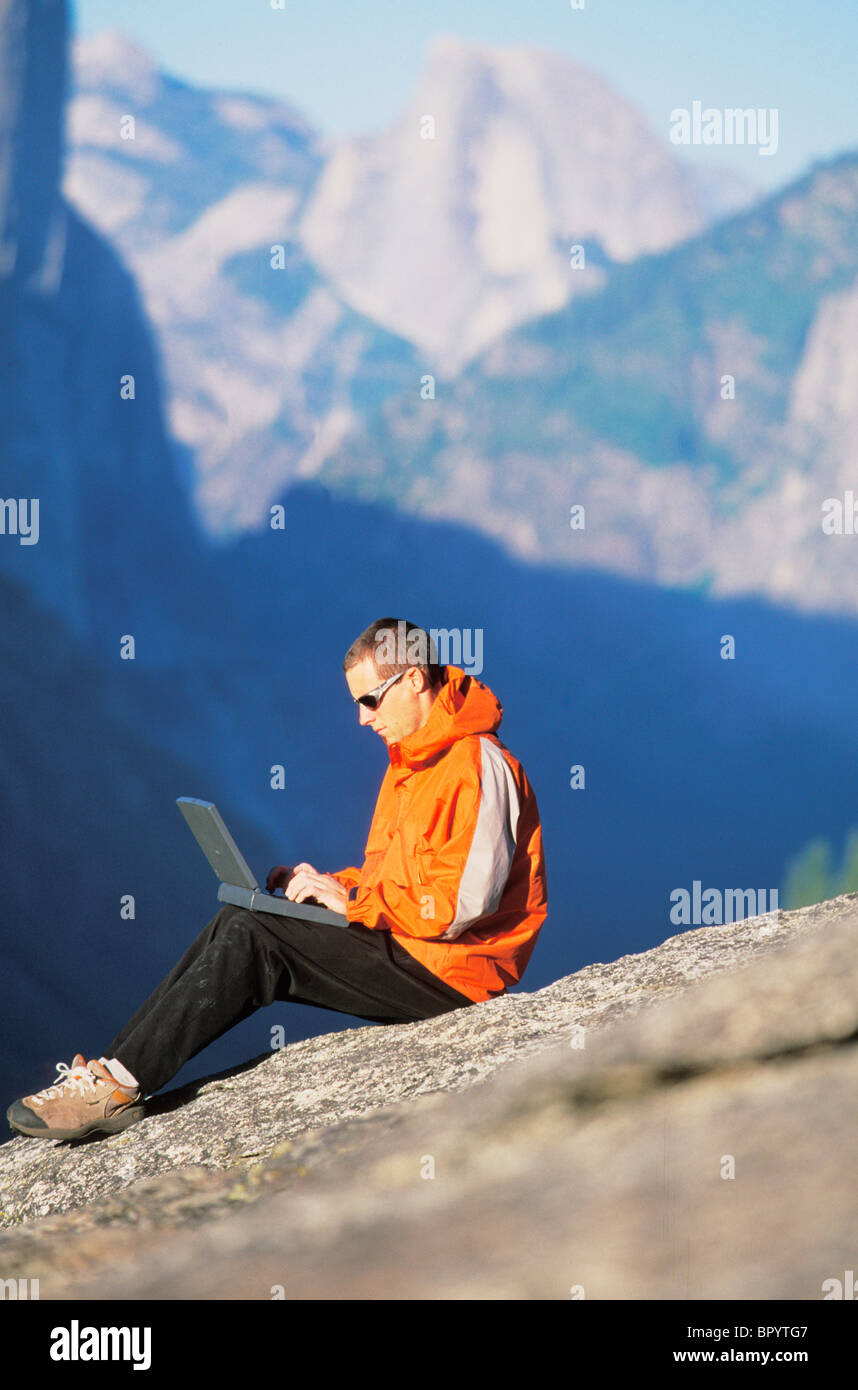 A man uses technology in backcountry Stock Photo Alamy