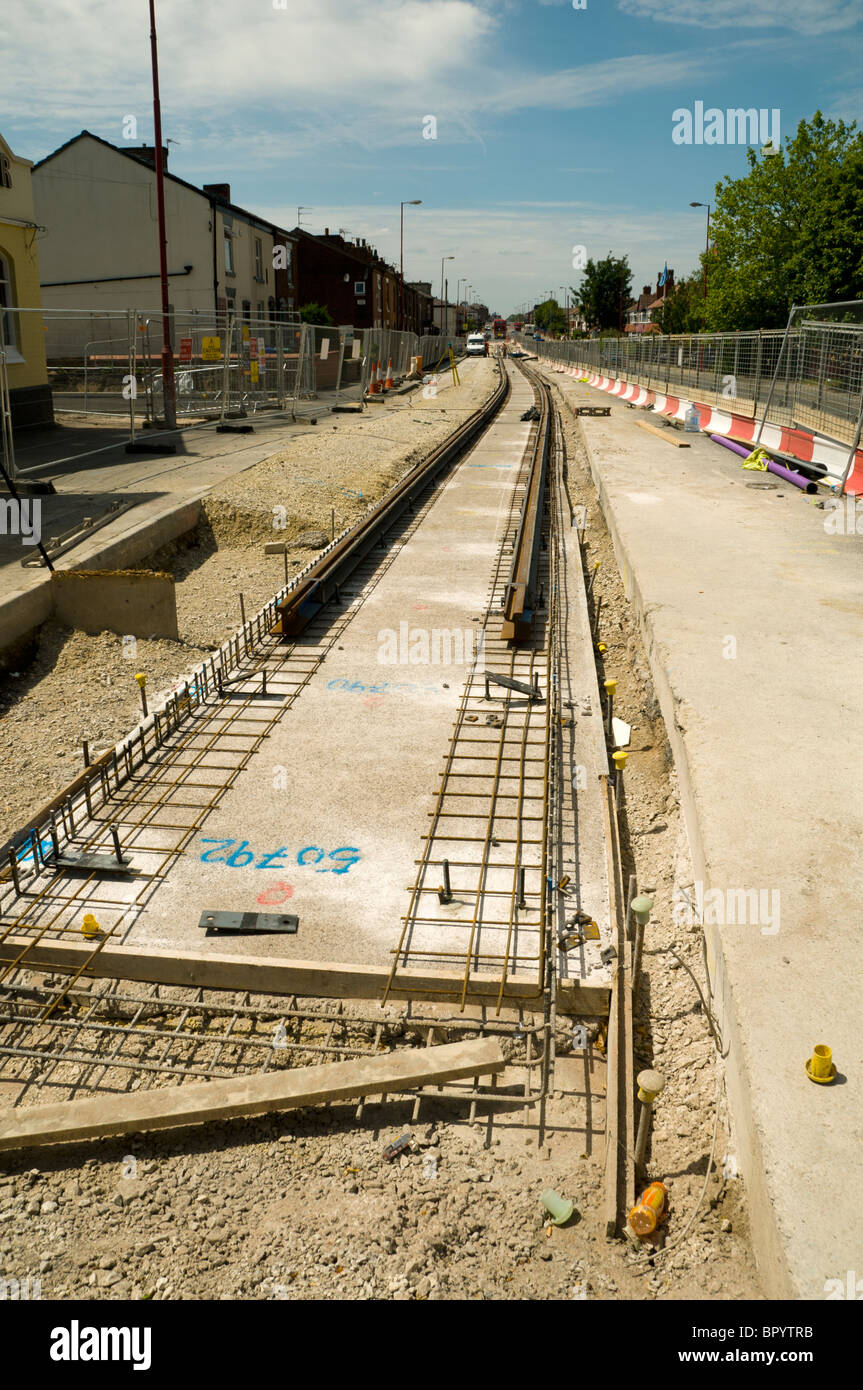Metrolink on-street light rail (tram) system under construction on Manchester Road, Droylsden, Tameside, Manchester, England, UK Stock Photo