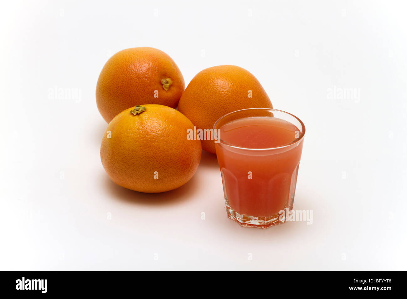 Grapefruits with a glass of juice Stock Photo Alamy