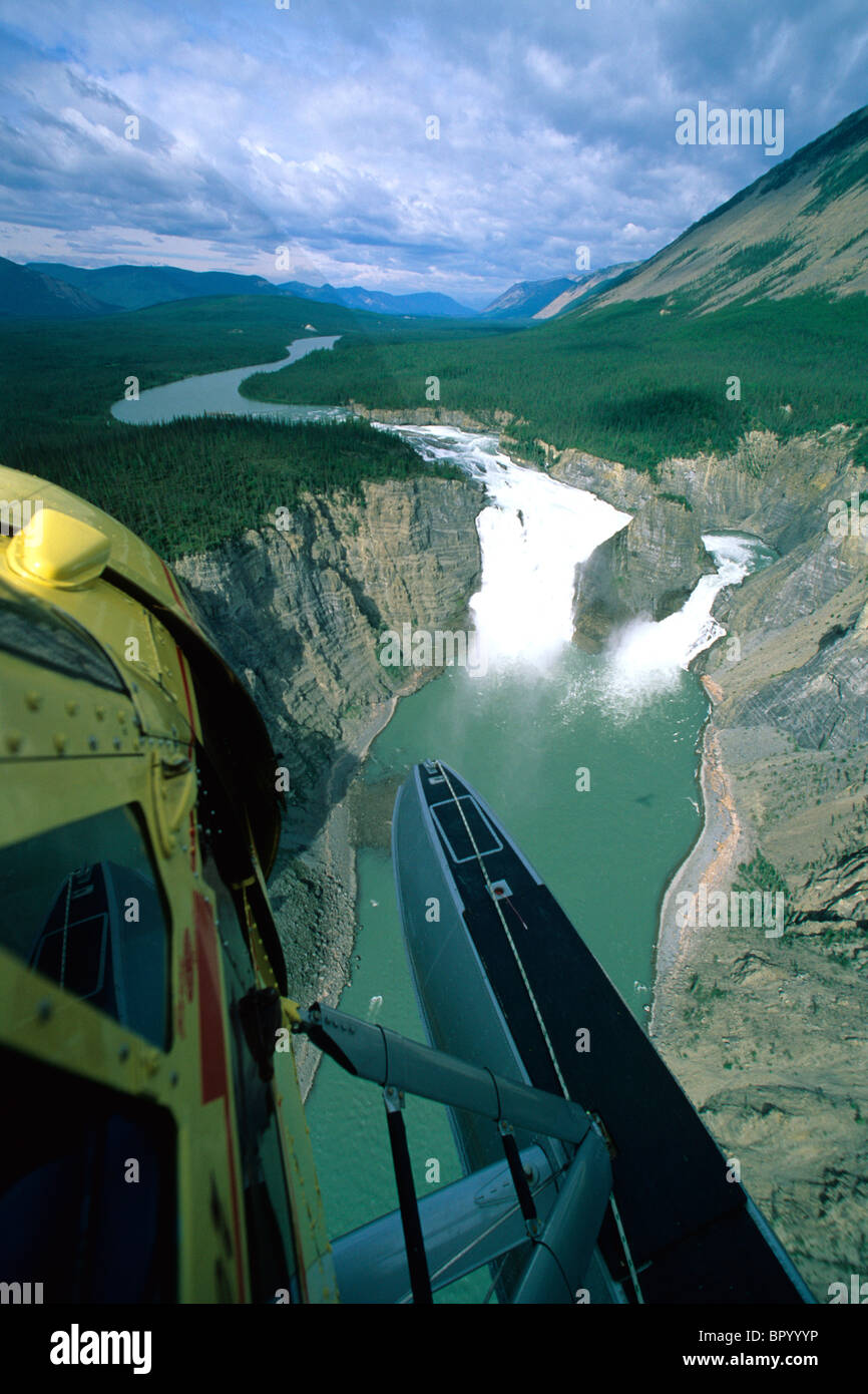 DeHavilland Beaver floatplane flies over Virginia Falls on the South Nahanni River in the Northwest Territories, Canada Stock Photo