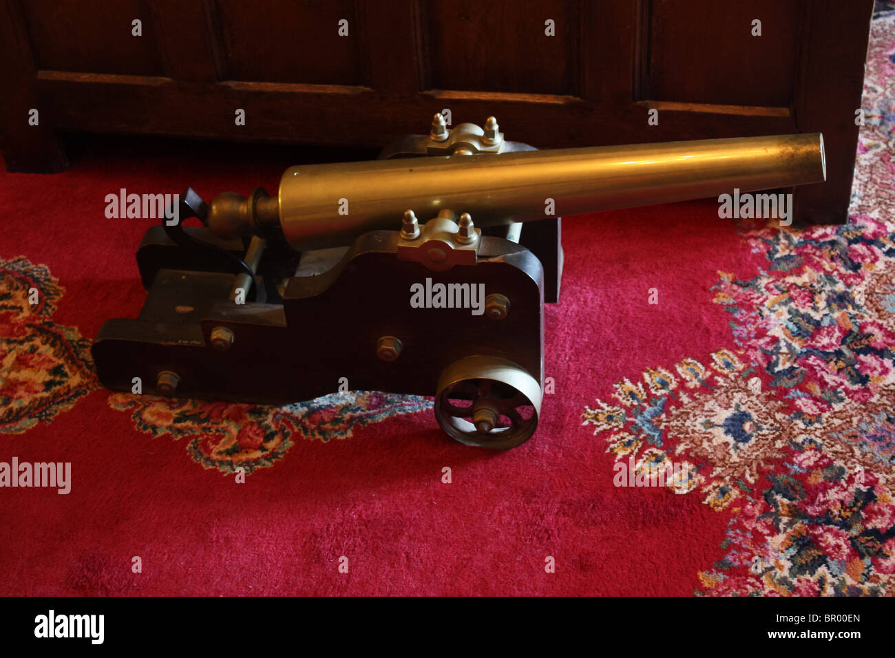 old retro vintage toy cannon red carpet Stock Photo