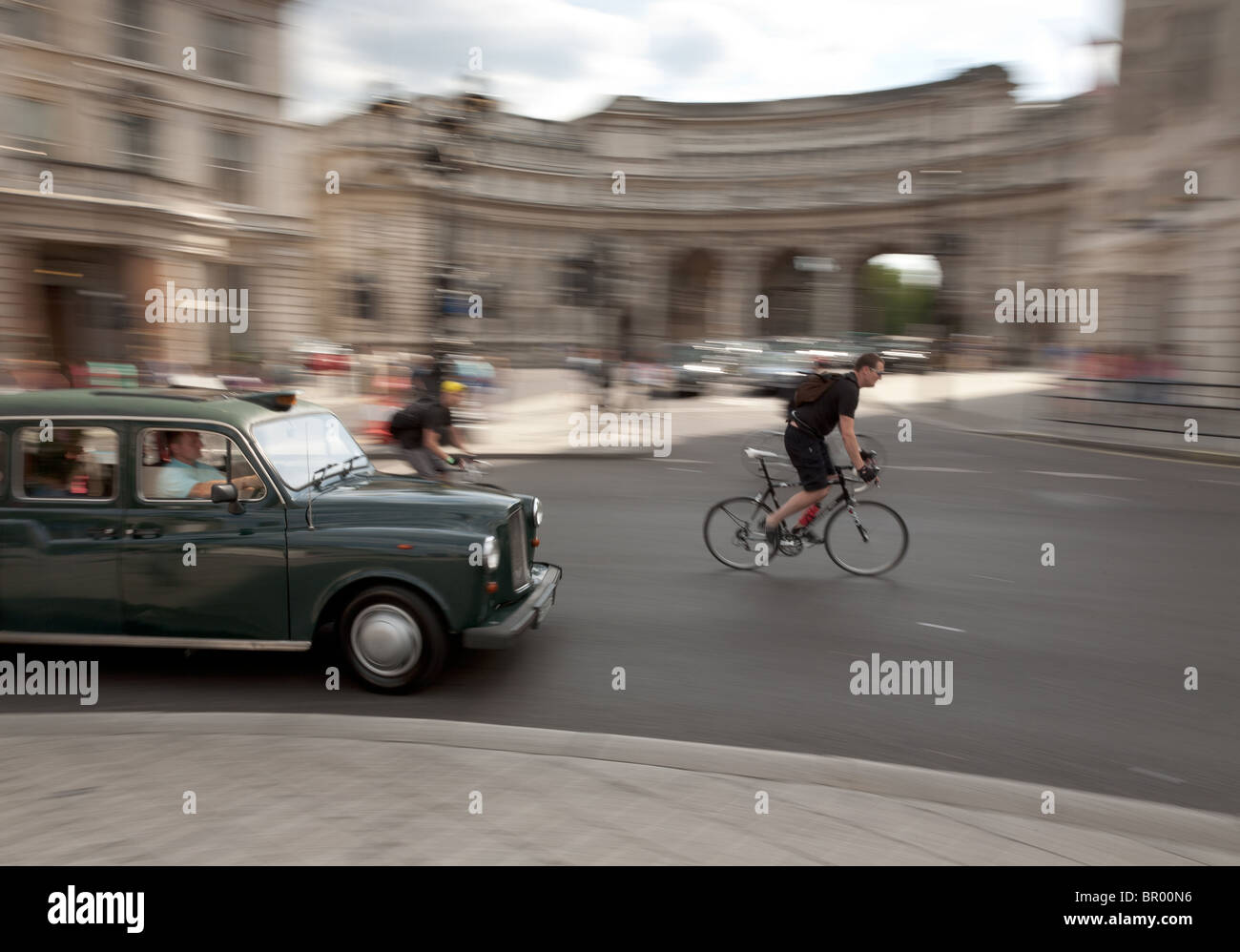 Cyclist and taxi in Trafalgar Square, London Stock Photo