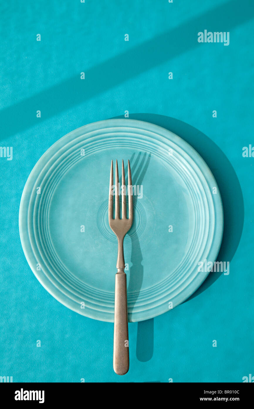 fork on blue fiesta plate Stock Photo