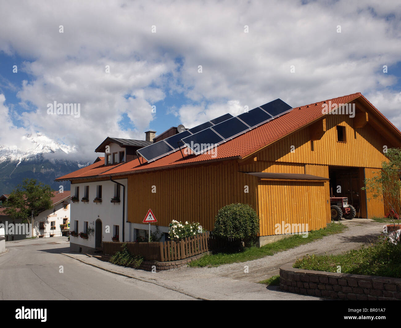 Solar panels for water heating on the roof of a barn in the village of Sistrans near Innsbruck in the Austrian Tirol Stock Photo