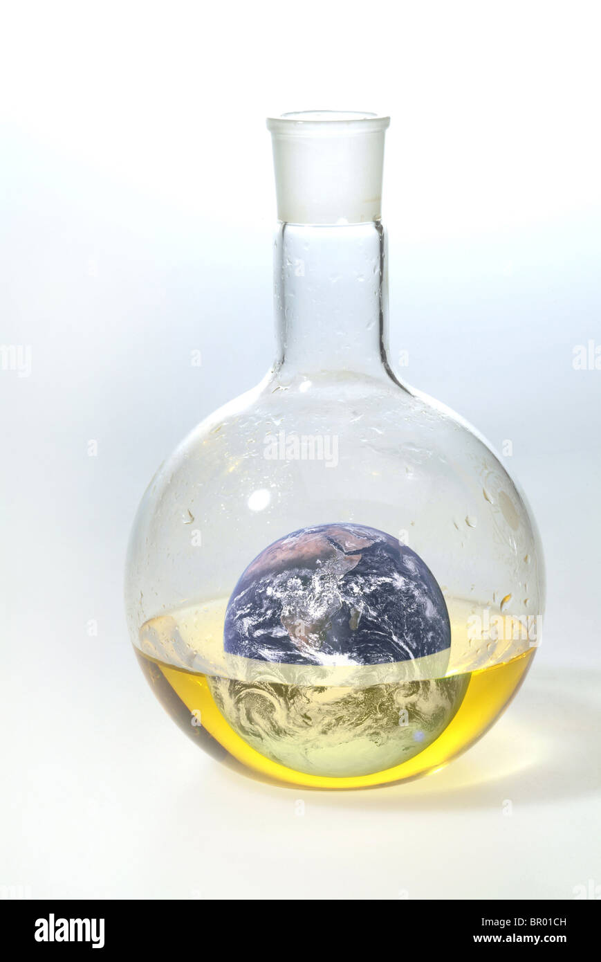 The Earth image in a flask filled with liquid. Stock Photo