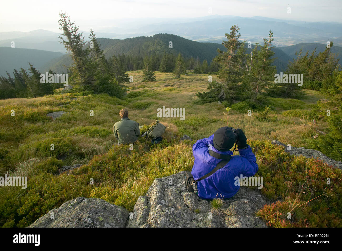 Two hikers taking a break to enjoy the views,Low Tatra Mountains, Slovakia Stock Photo