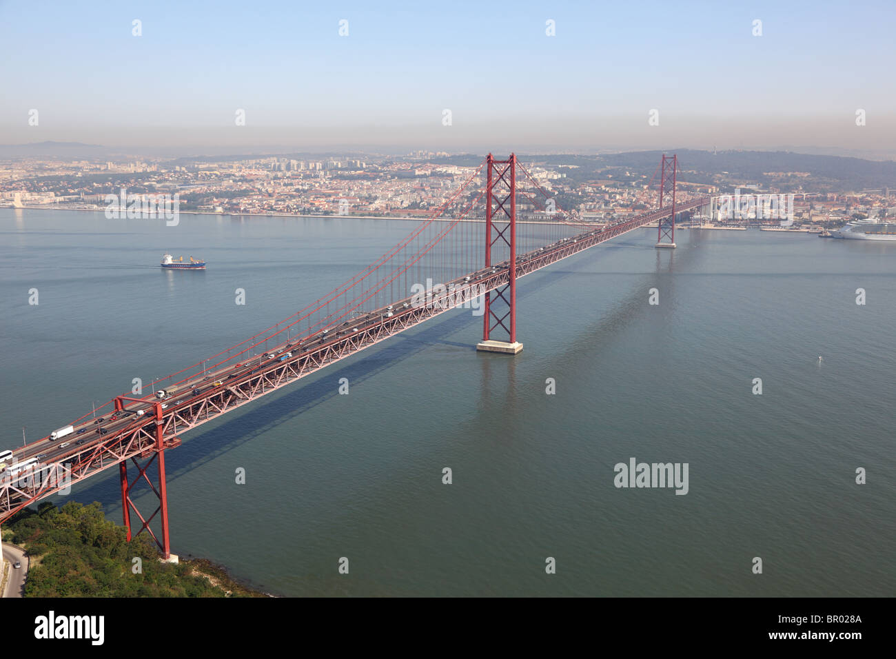 The 25 de Abril Bridge - cable-stayed bridge over the Tagus river in Lisbon, Portugal Stock Photo