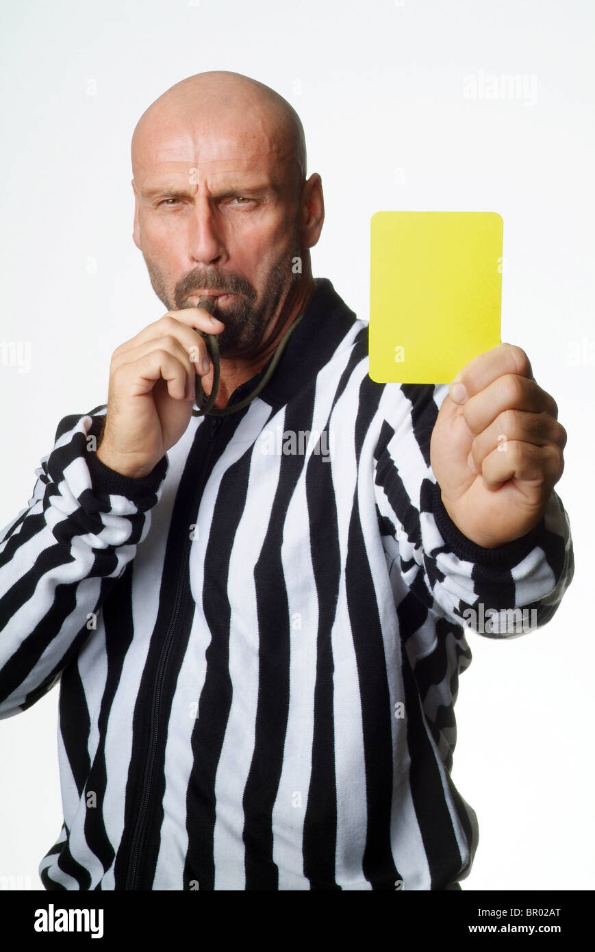 A soccer referee showing a yellow card Stock Photo