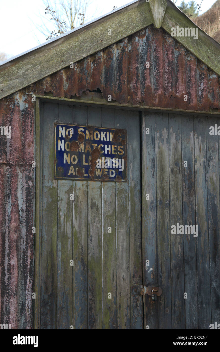 Old rusty shed with weathered sign No Smoking No Matches No Lights Allowed Stonehaven Harbour, Aberdeenshire, Scotland Stock Photo