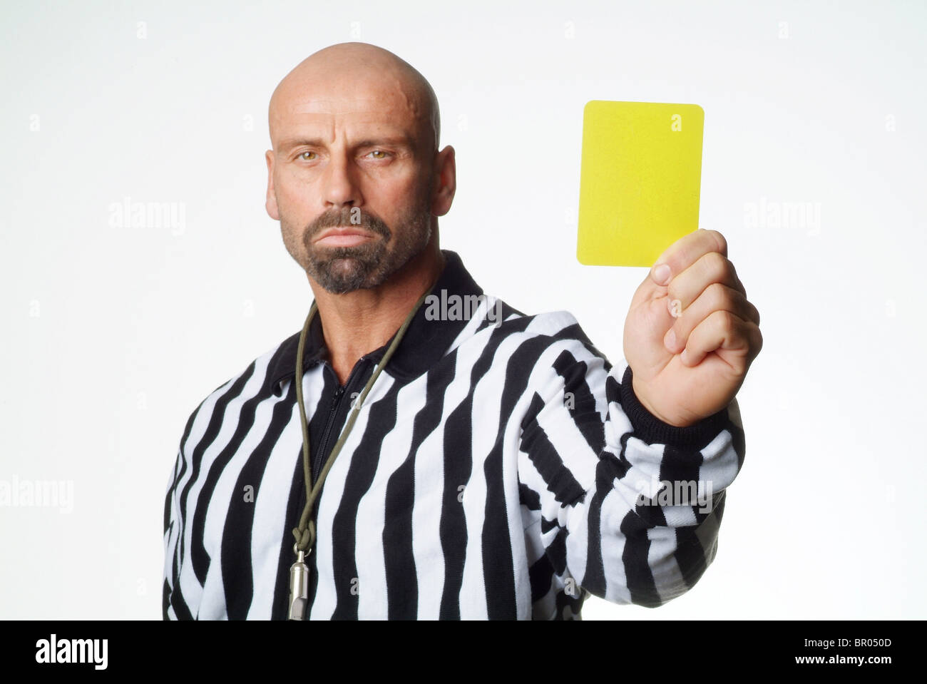 A soccer referee showing a yellow card Stock Photo