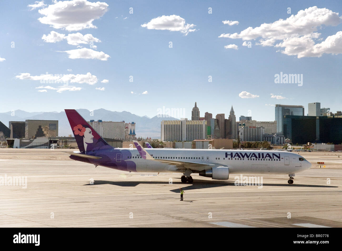 A Hawaiian  airlines plane on the tarmac at Las Vegas airport with the strip in background, Las Vegas Nevada USA Stock Photo