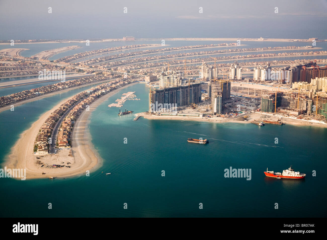 UAE, Dubai. Aerial of Palm Jumeirah artificial islands shaped like palm fronds, and apartment towers. Stock Photo
