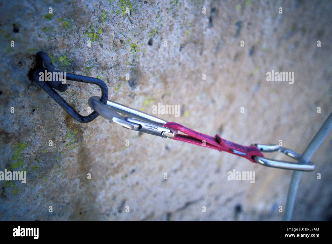 A quick draw hangs from an old bolt on a climbing route Stock Photo Alamy