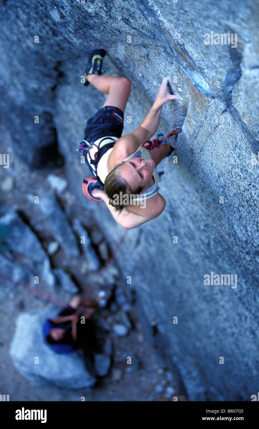 A female rock climber leading climbing a big granite wall in Yosemite