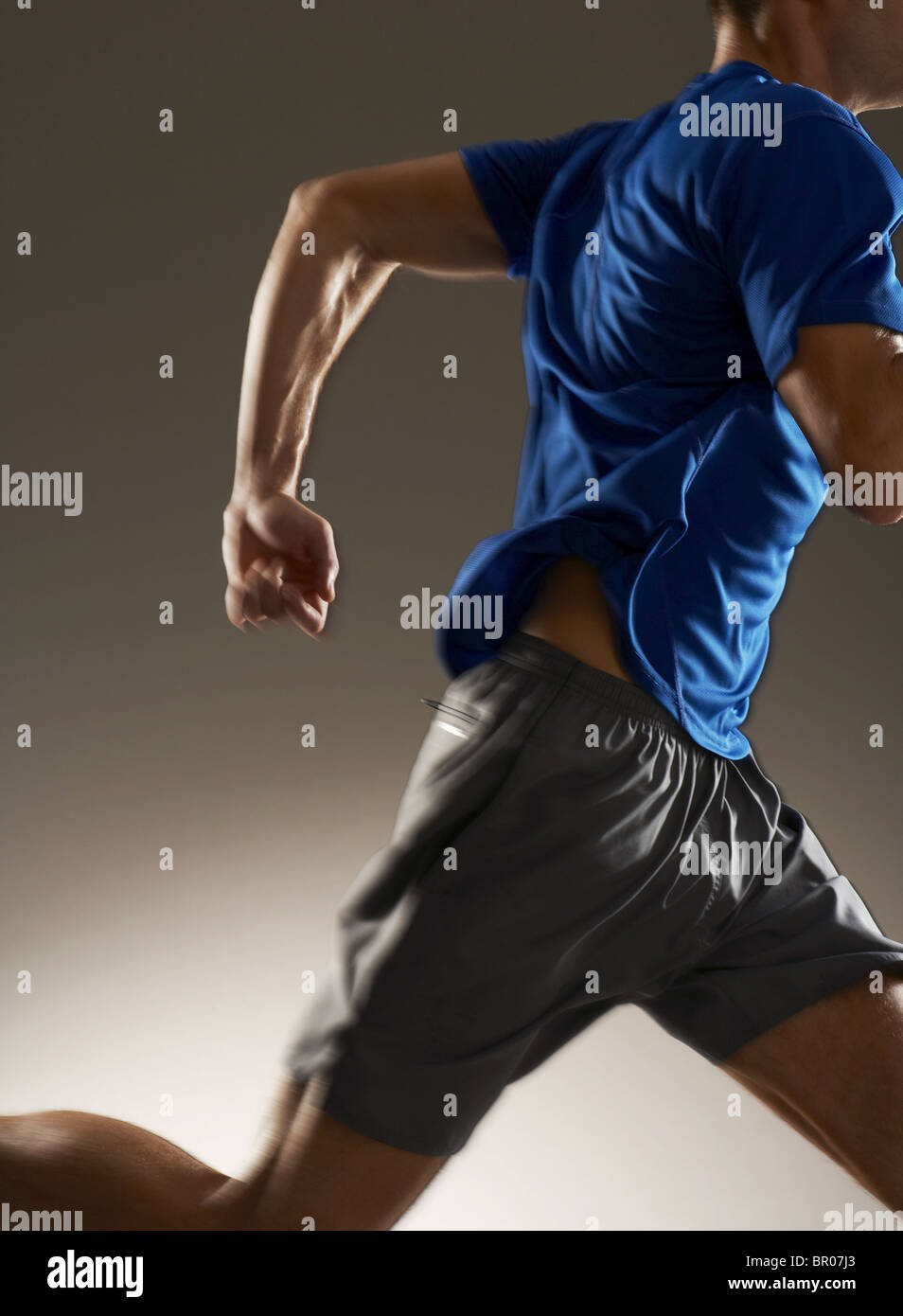 Caucasian man in athletic clothes running shot in studio Stock Photo