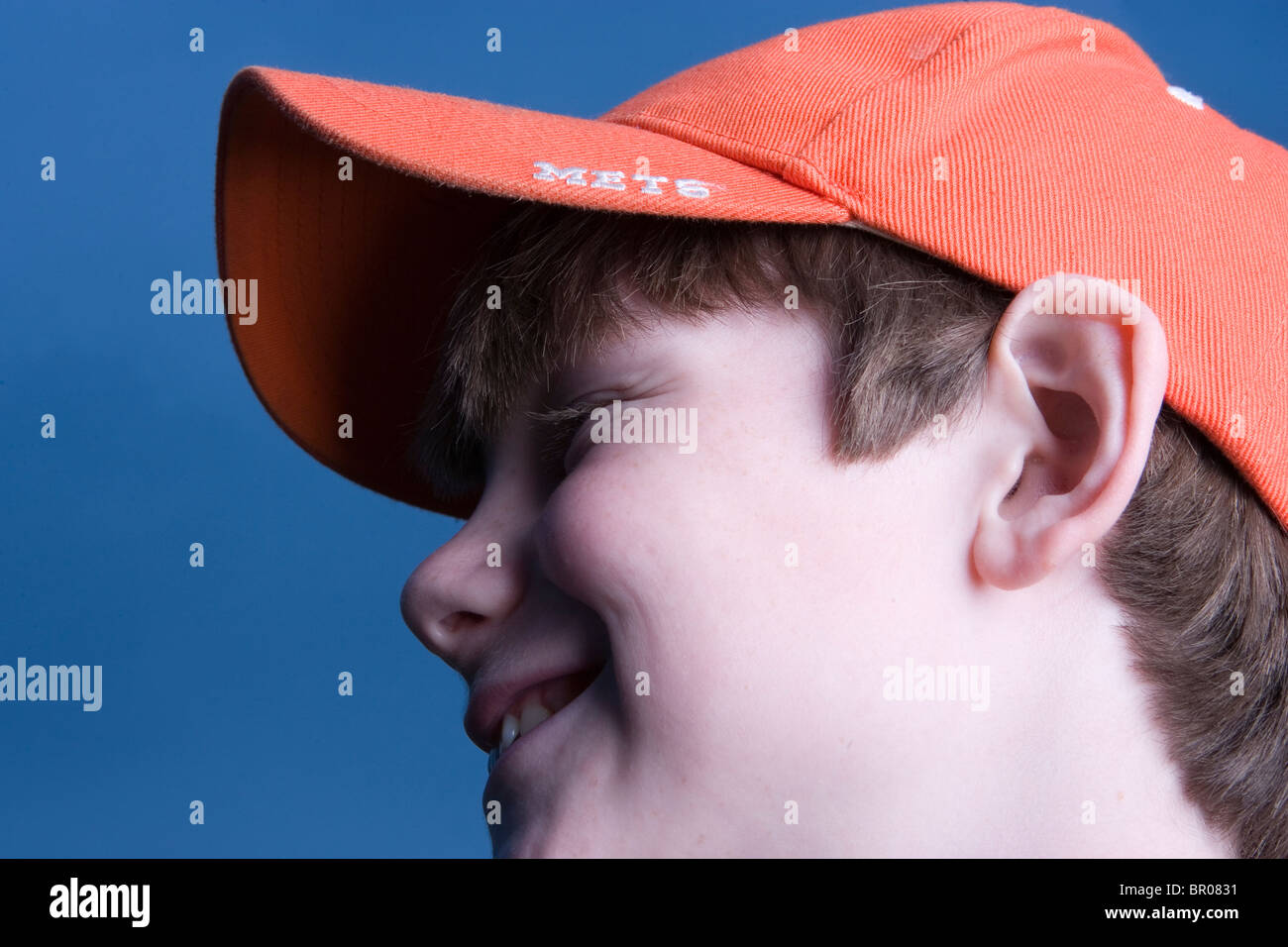 A young boy wears the hat of his favorite baseball team in Queens, New