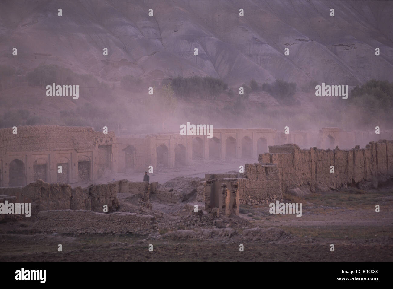 Dust swirls amongst the ruined buildings of the old Bamiyan bazaar Stock Photo