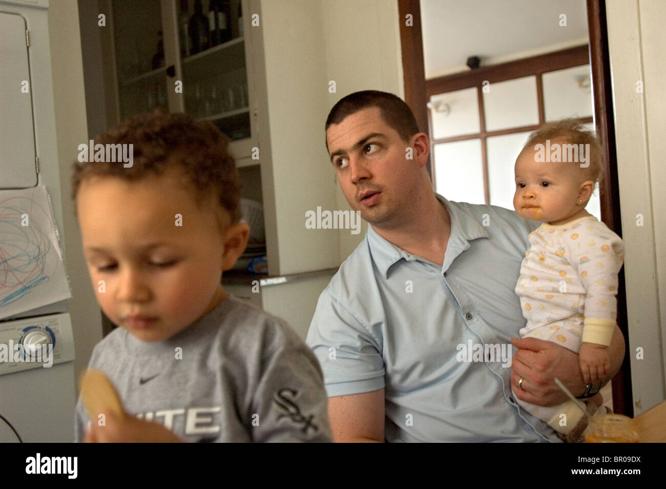 A young family sits in the kitchen Stock Photo