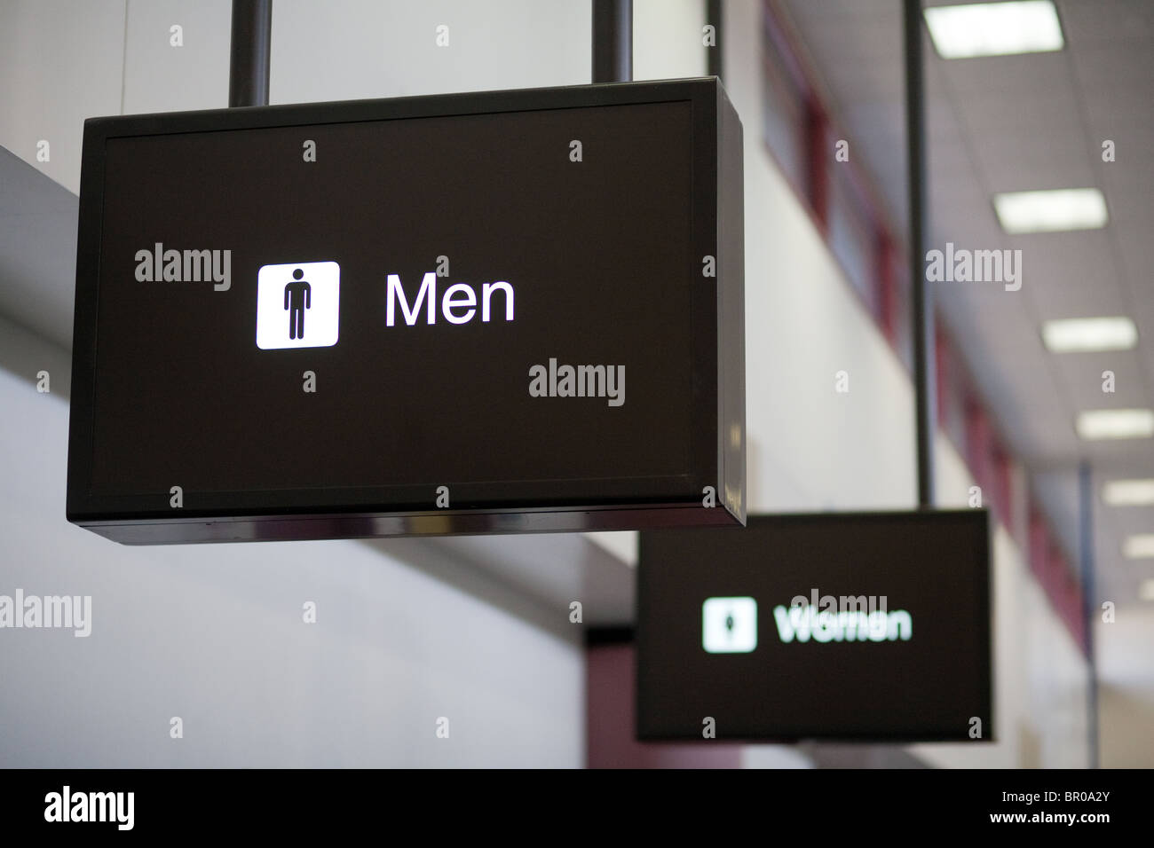 Men and women signs, Las Vegas airport toilets, Nevada USA - Concept: Men ahead of women; Men in front of women; Women behind men Stock Photo