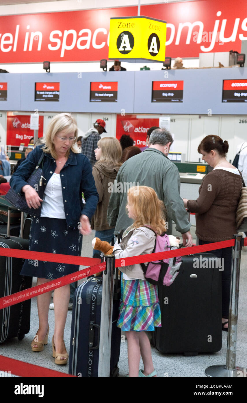 People Queuing At The Baggage Check In Desk For Virgin Atlantic