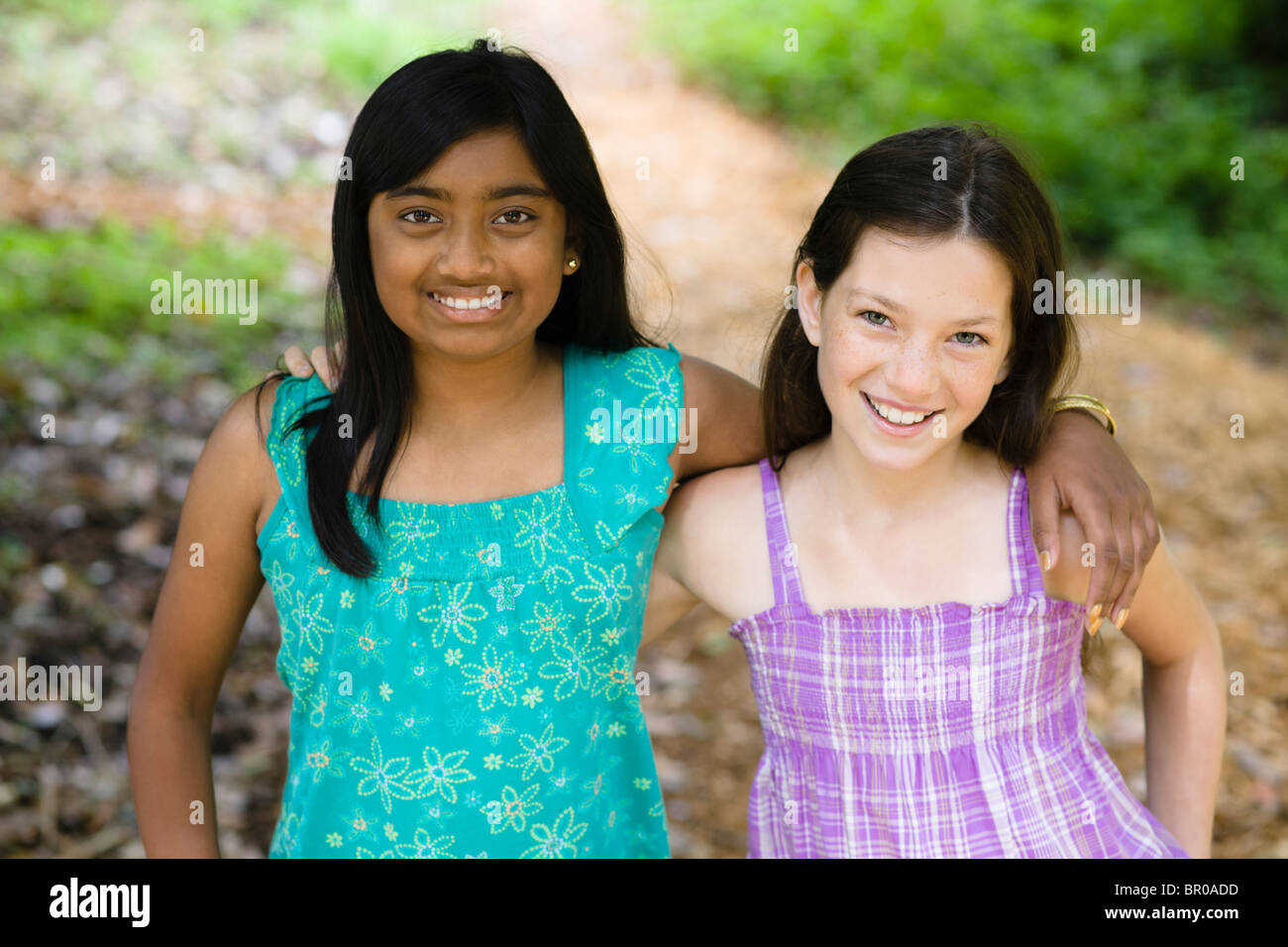 Smiling girls hugging outdoors Stock Photo - Alamy