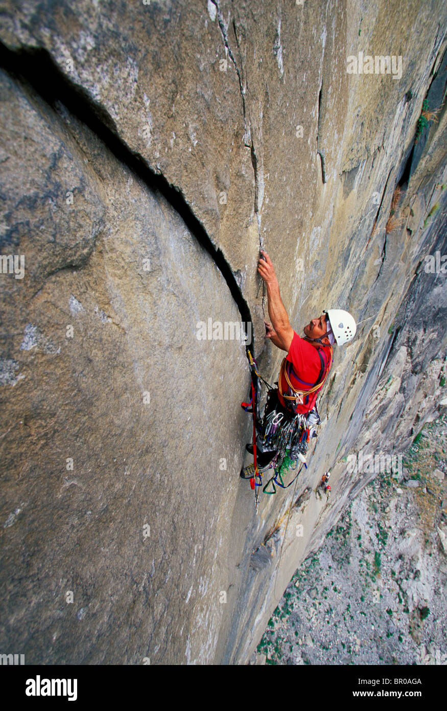 A male rock climber aid climbing on a big granite wall in Yosemite National Park. Stock Photo