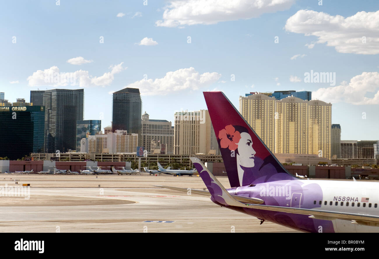 A Hawaiian  airlines plane on the tarmac at Las Vegas airport with the strip in background, Las Vegas Nevada USA Stock Photo