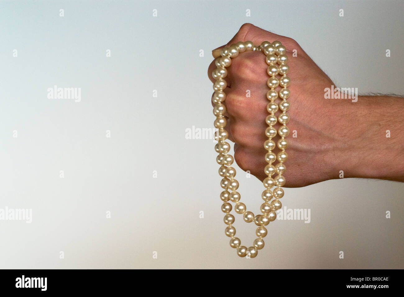 male-hand-clutching-pearls-BR0CAE.jpg