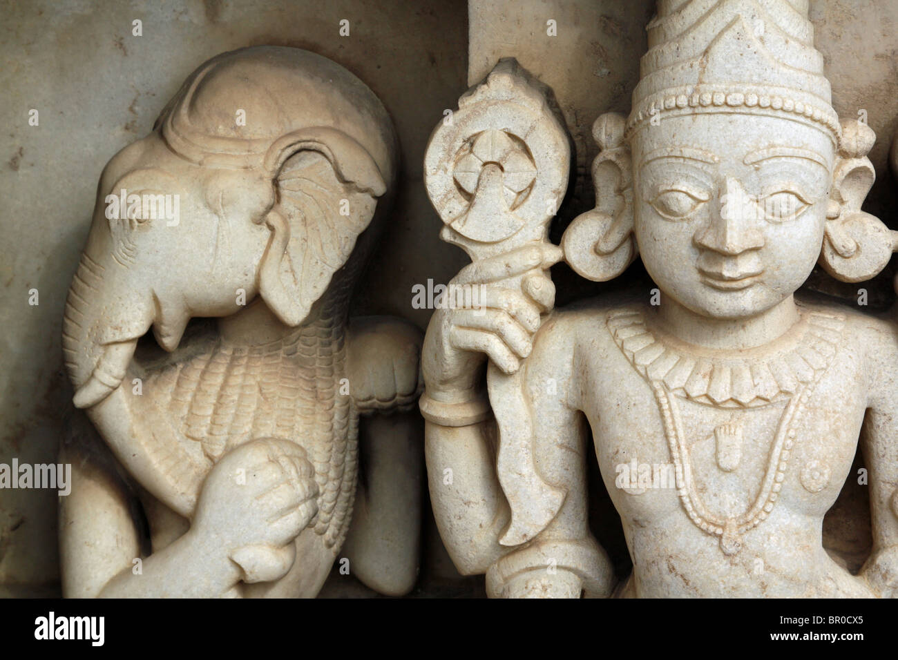 Ancient white stone sculptures of Ganesha and Krishna decorating a Hindu temple in Udaipur, Rajasthan, India. Stock Photo