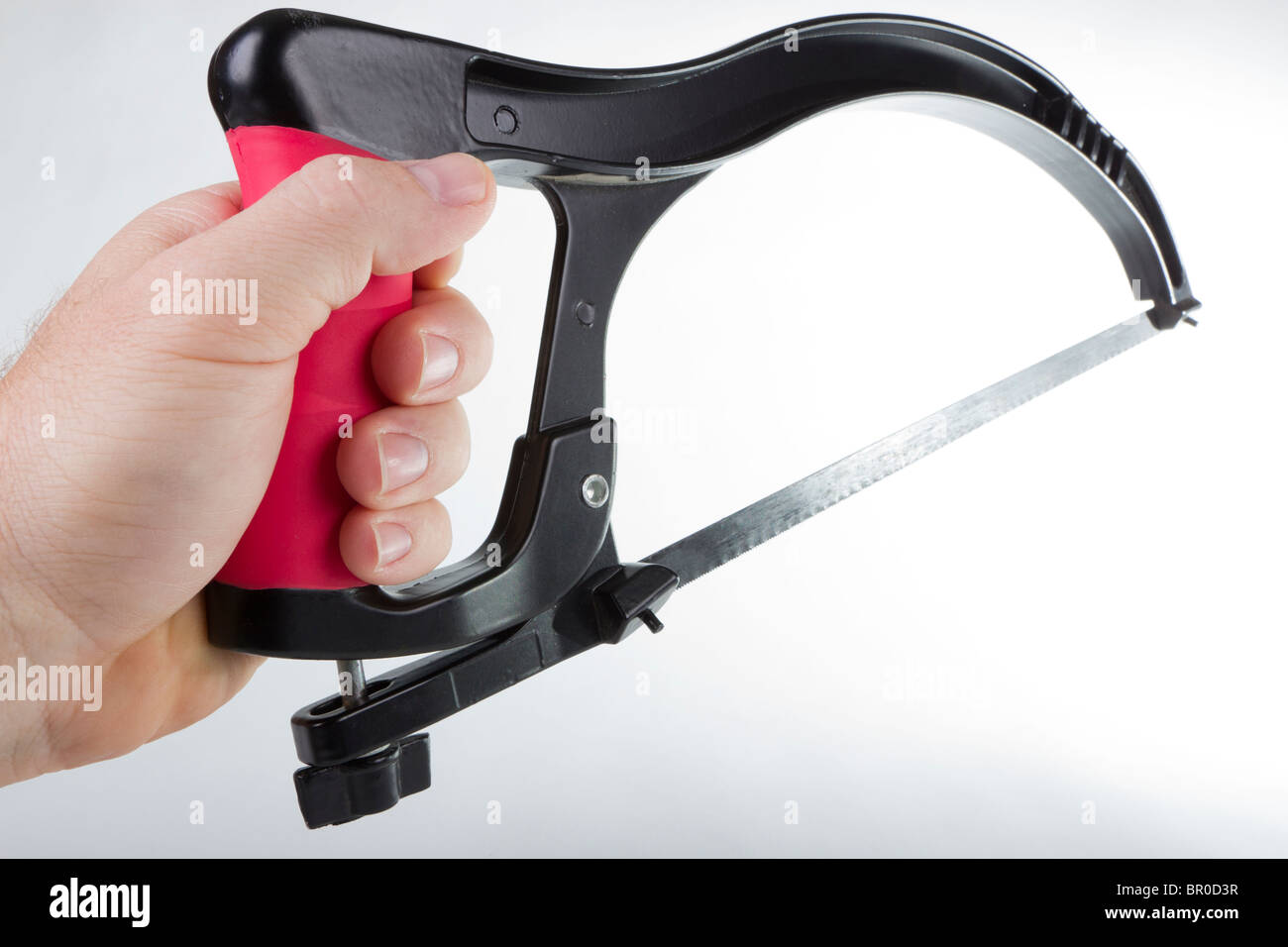 Steel hack saw in white male hand Stock Photo