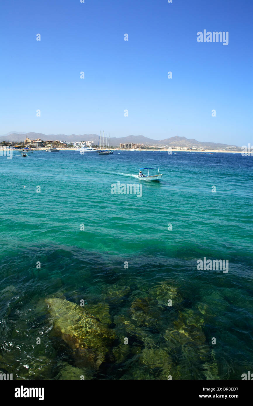 Water Taxi heads into the rock jetty that protects the harbor in Cabo San Lucas in Baja, Mexico. Stock Photo
