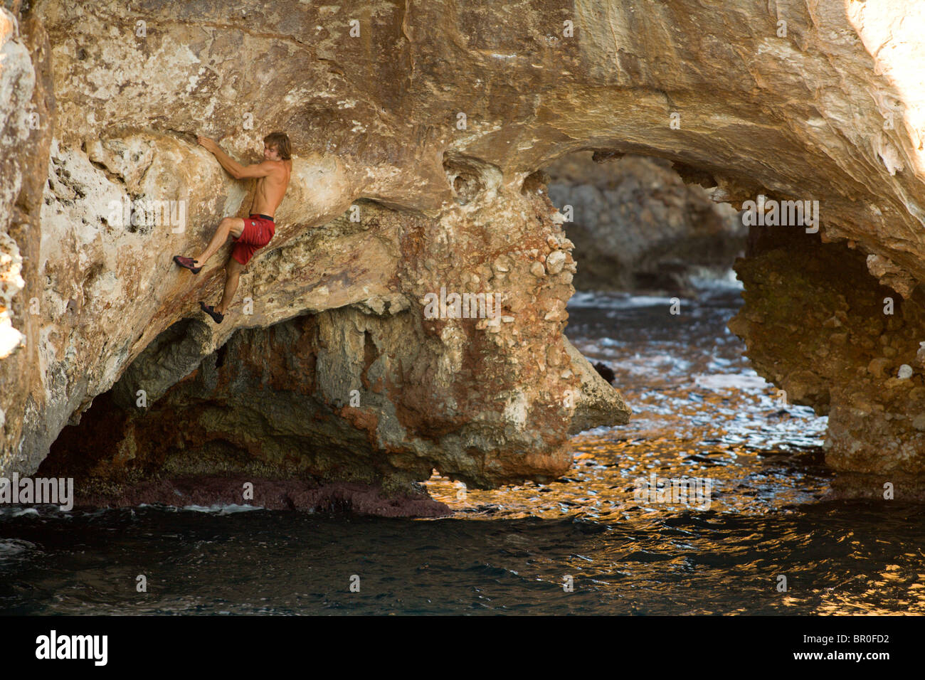 Chris Sharma rock climbing / deep water soloing Stock Photo Alamy