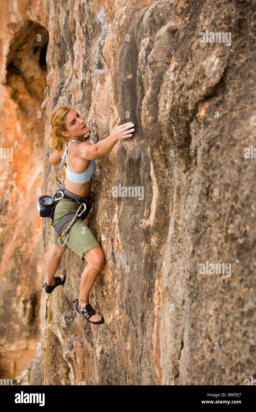 A woman rock climbing. Stock Photo