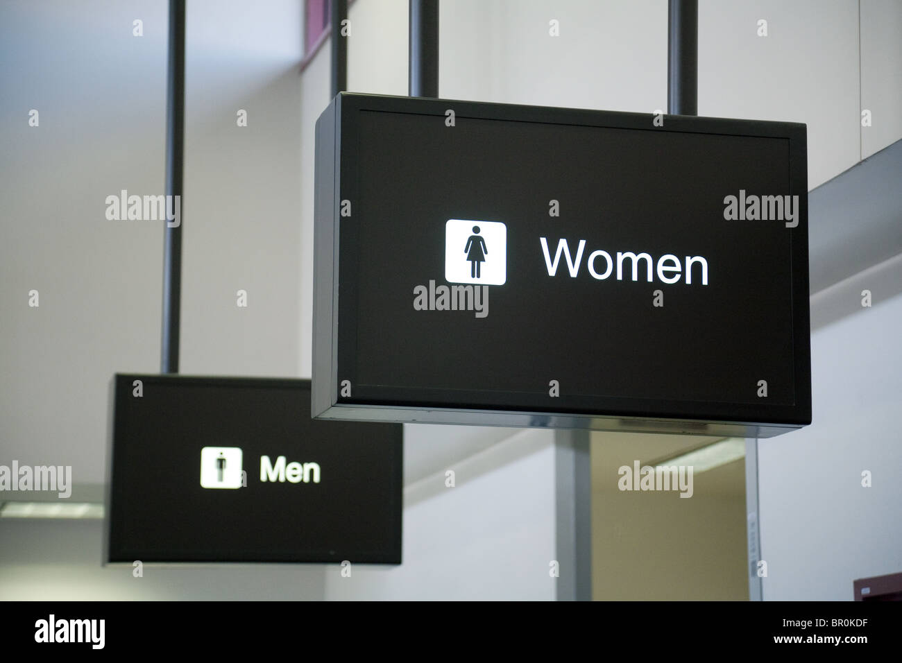 Men and women signs, Las Vegas airport toilets; Nevada USA. Concept Women ahead of men; Women in front of men; Men behind women. Stock Photo