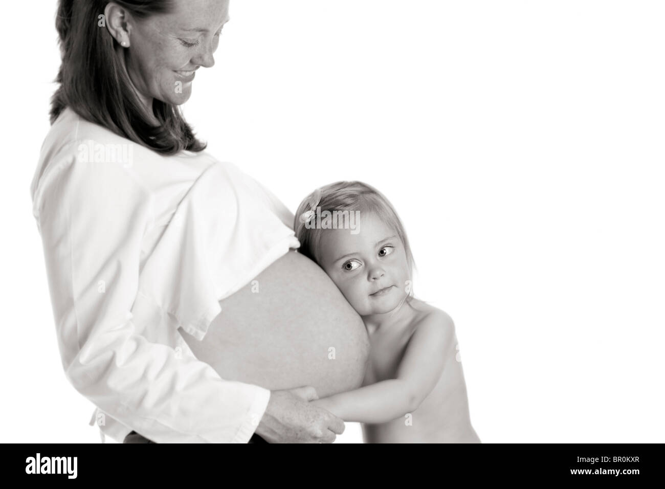 Caucasian pregnant woman hugging daughter Stock Photo