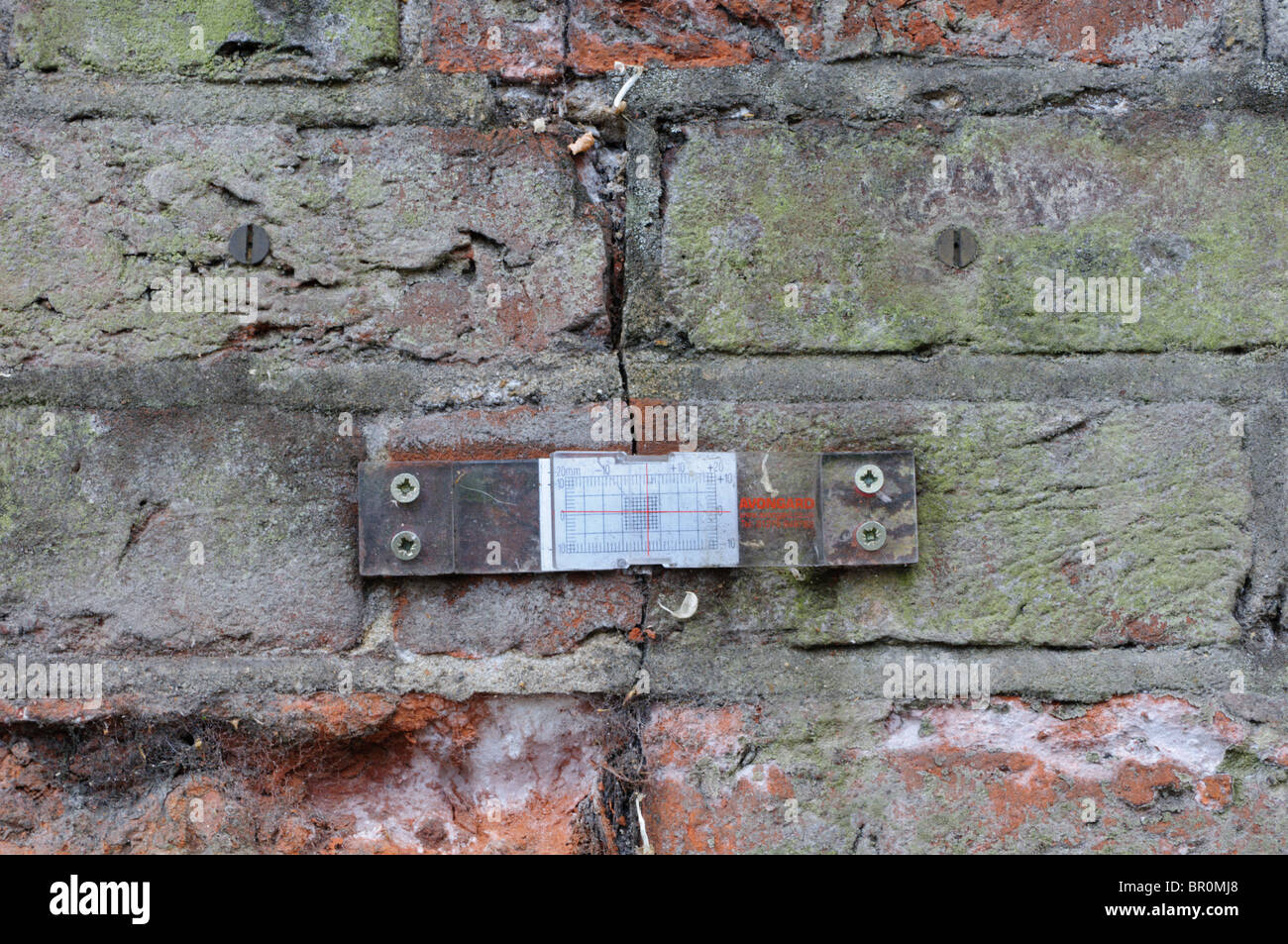 A tell-tale placed across a structural crack in brickwork to measure any change or worsening over time Stock Photo