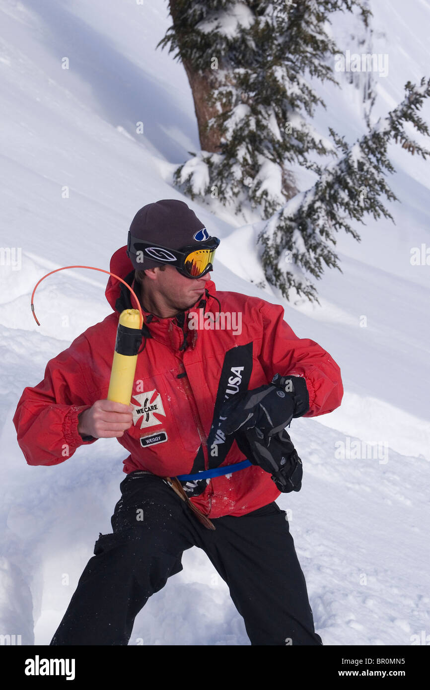A ski patroller throwing explosives for avalanche control at Squaw