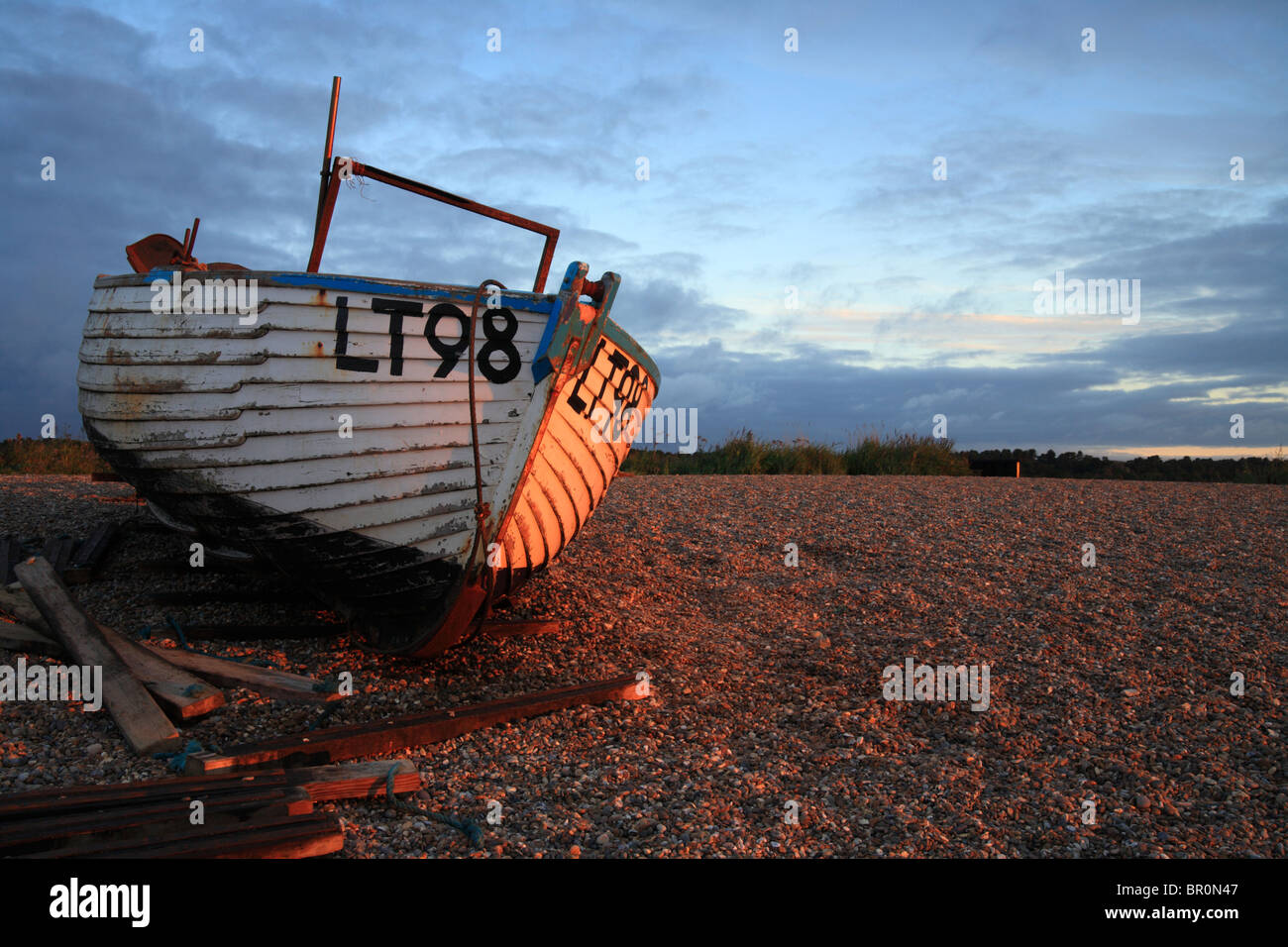 Dunwich fishing boat at dawn pulled up on the shingle beach, Suffolk Coast, East Anglia, England, UK Stock Photo
