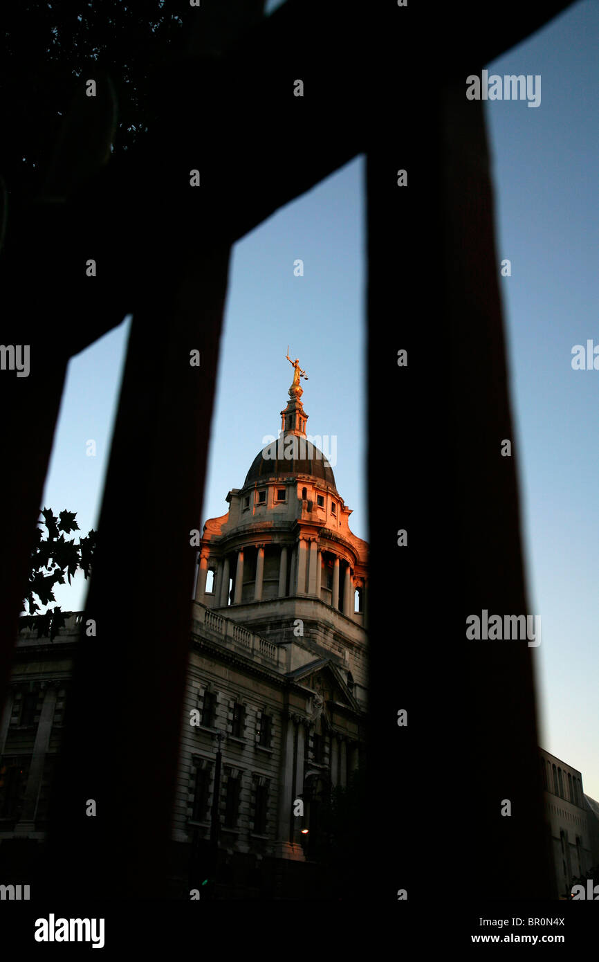 Looking through the railings of St Sepulchre without Newgate church to the Old Bailey (Central Criminal Court), City of London Stock Photo