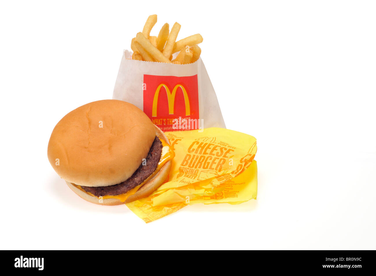 McDonald's cheeseburger and french fries on white background cutout. Stock Photo