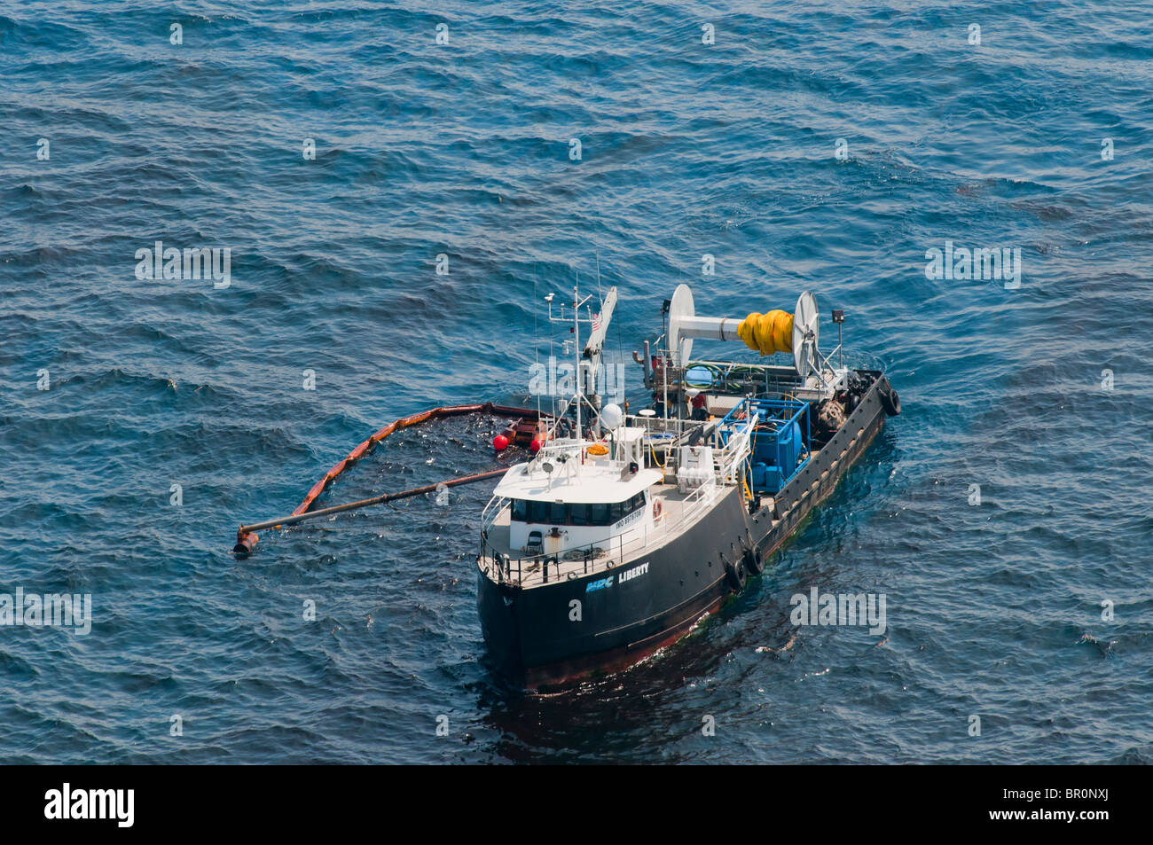 Oil skimming boat collecting oil three miles north of the source MC 252 site, Gulf of Mexico, USA. Stock Photo