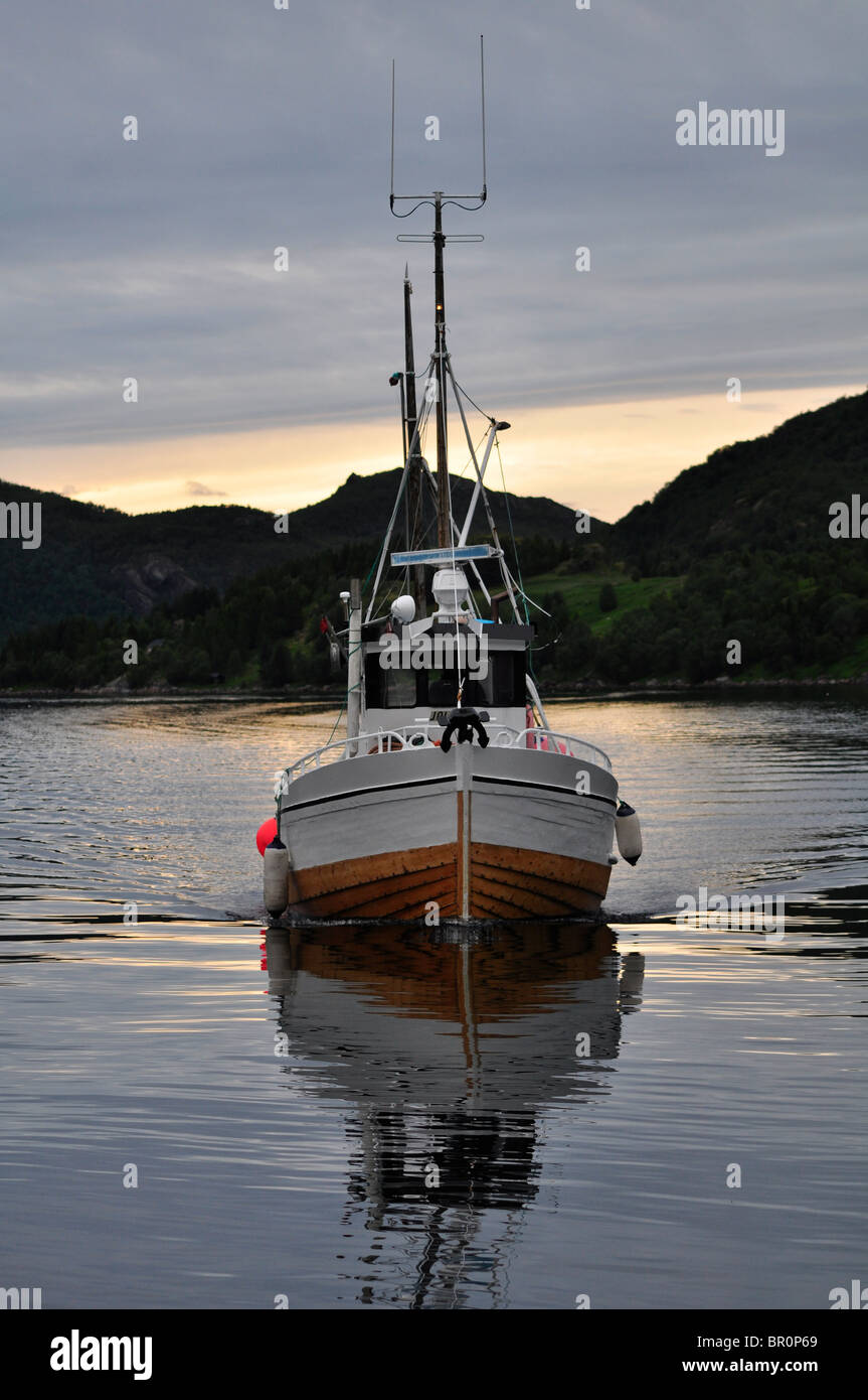 a fishing boat in the sunset Stock Photo - Alamy